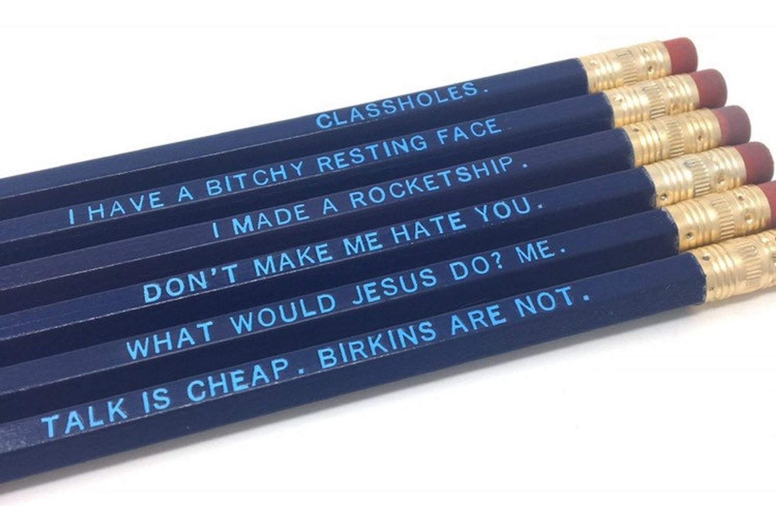 a set of blue pencils with phrases etched into it