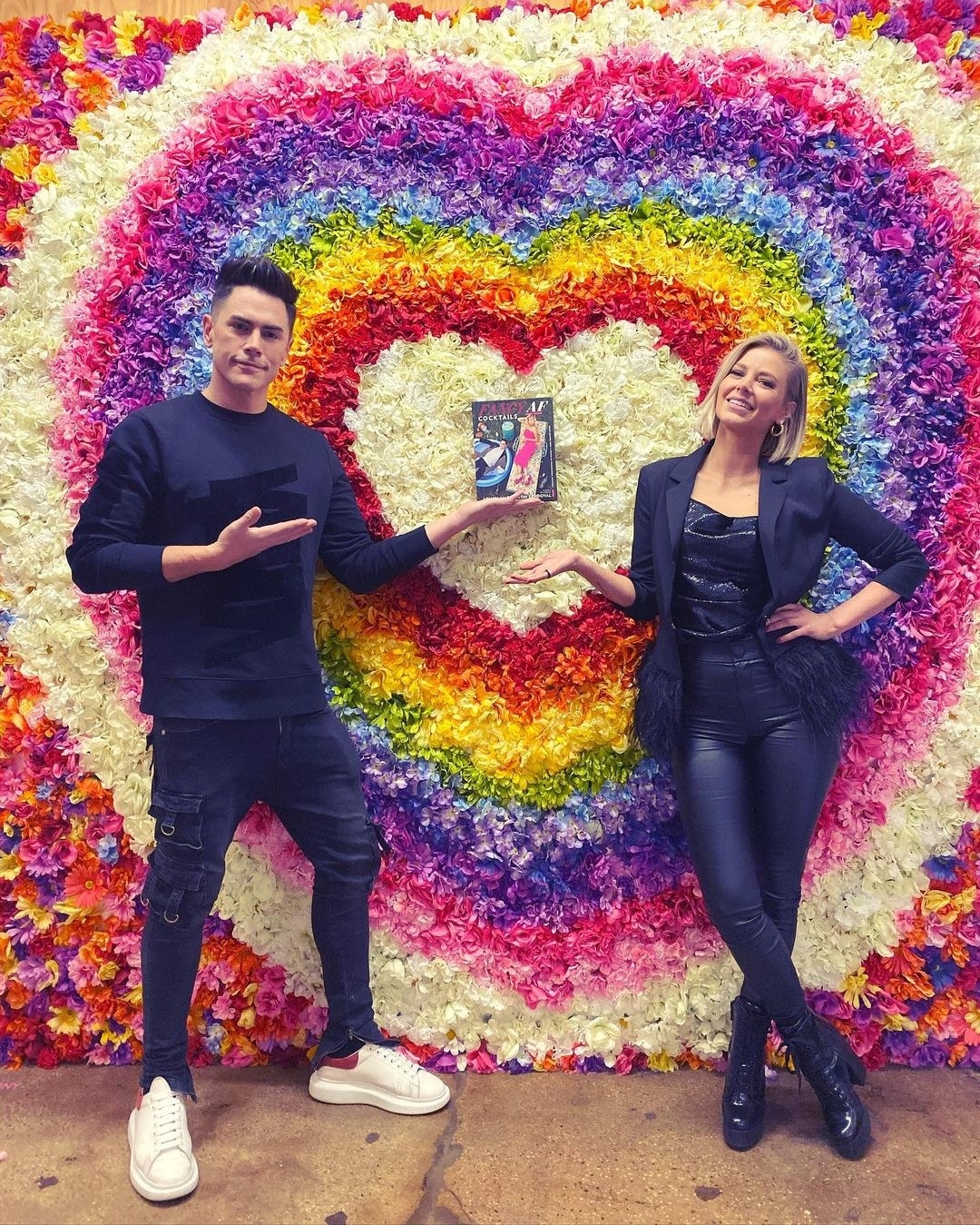 tom and ariana holding their book