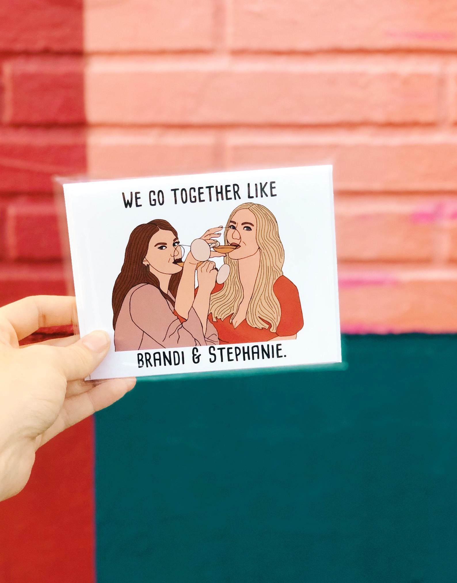 the card showing brandi and stephanie drinking wine together