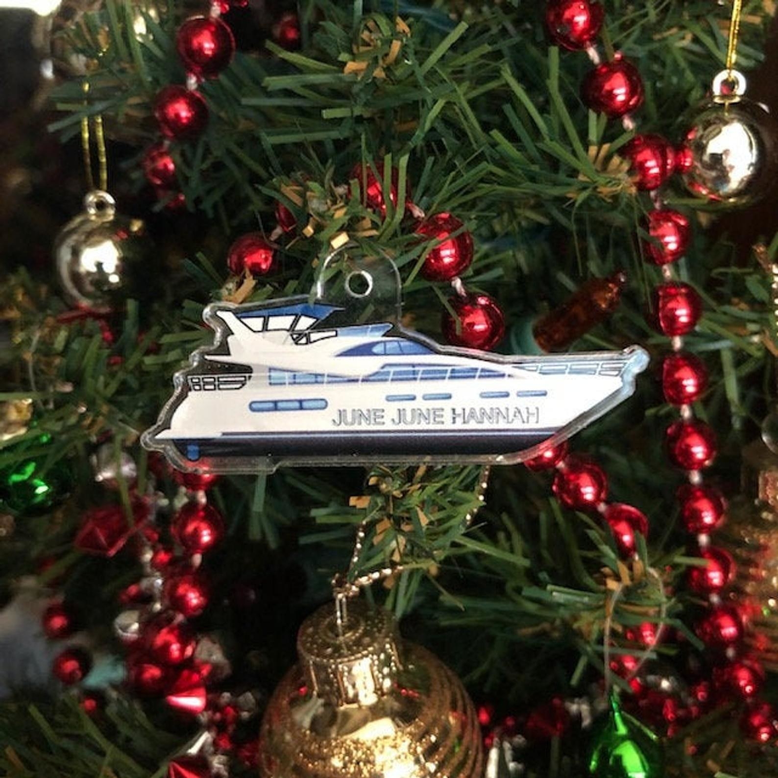 a boat shaped ornament with june june hannah on it