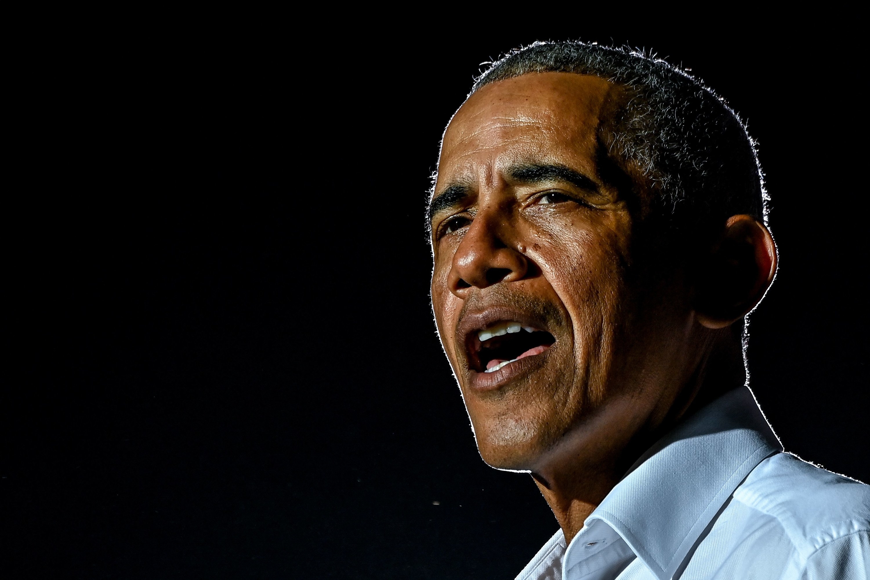 Former US President Barack Obama speaks at a drive-in rally as he campaigns for Democratic presidential candidate former Vice President Joe Biden in Miami, Florida on November 2, 2020