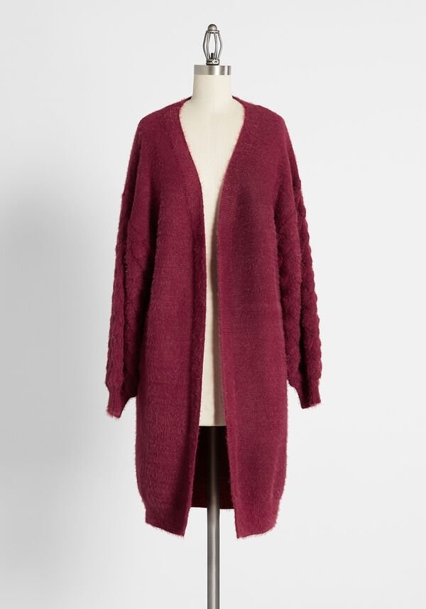the burgundy cardigan hanging on a mannequin