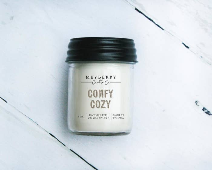 A candle jar on a wooden background