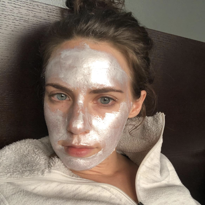 reviewer wearing the silver mask