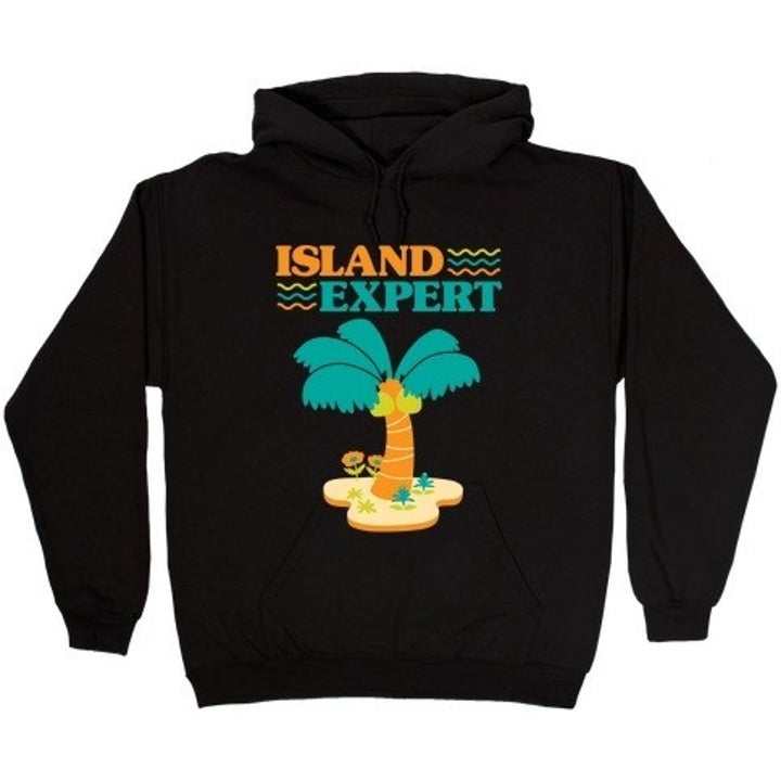 a black sweatshirt that says "island expert" on it with a picture of an animal crossing palm tree