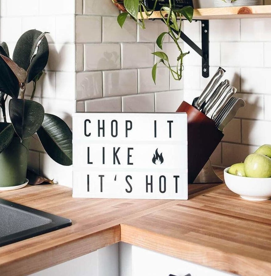 The marquee lightbox on a kitchen counter with the words &quot;chop it like it&#x27;s hot.&quot;