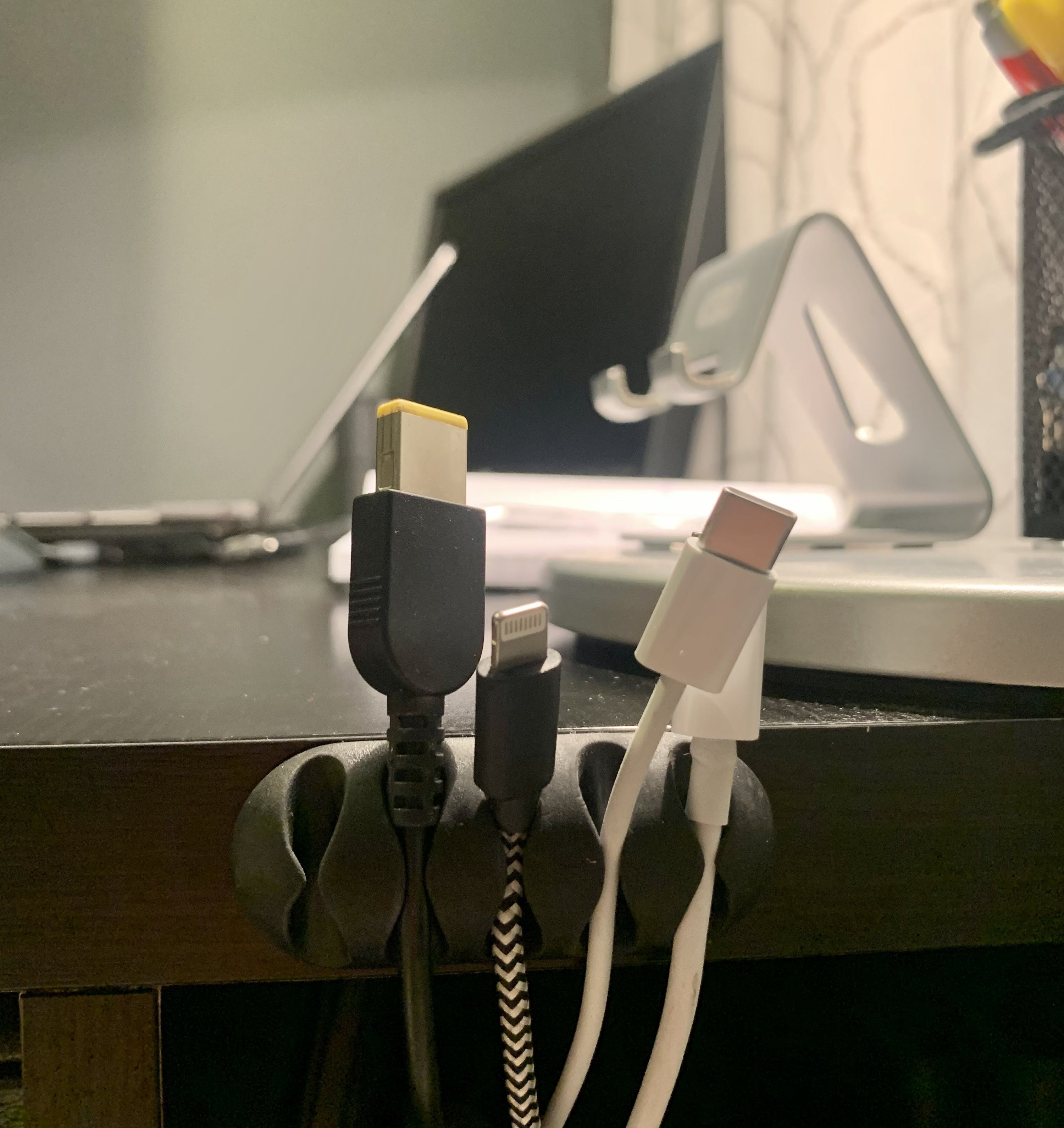 The cord clip is attached to May&#x27;s desk and keeps her cords organized