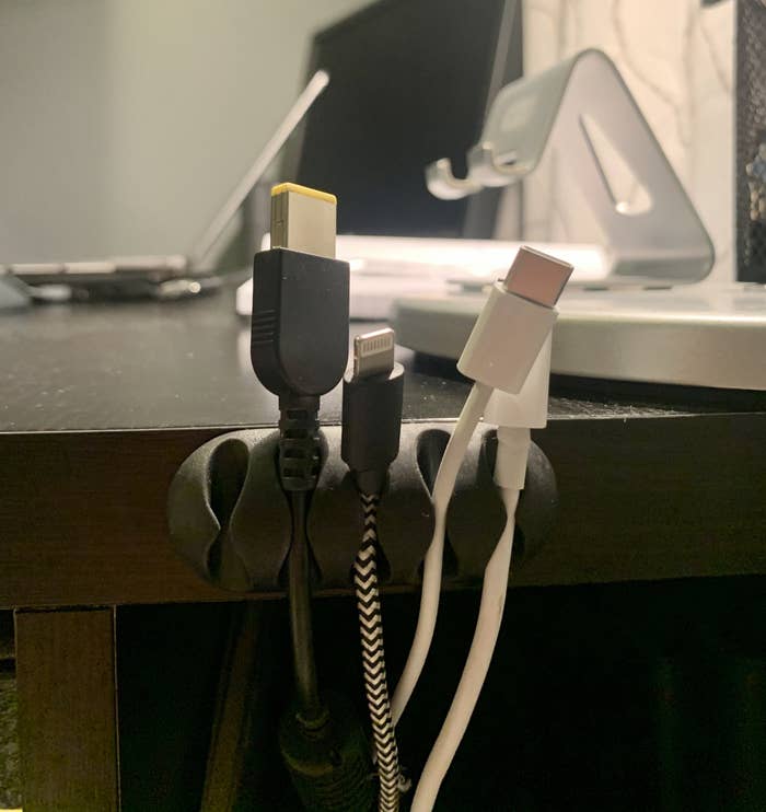 The cord clip is attached to May&#x27;s desk and keeps her cords organized