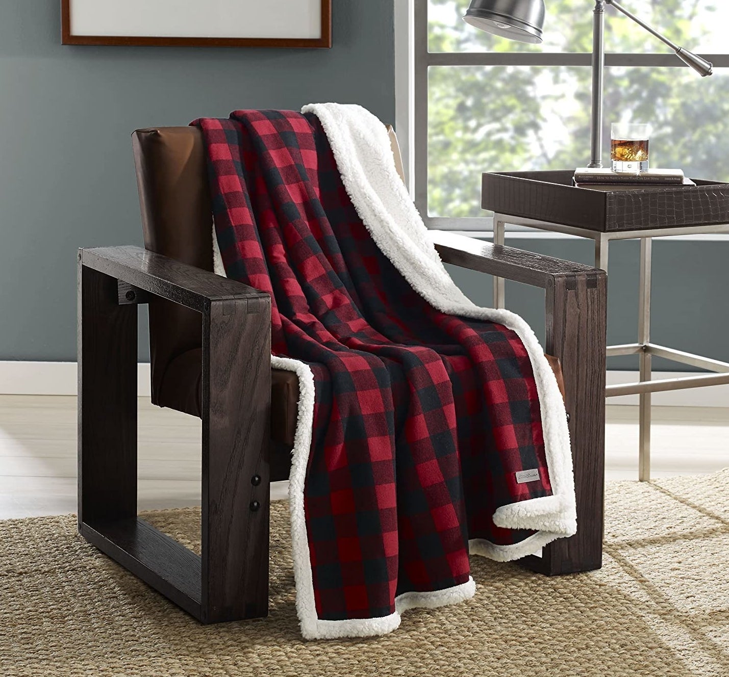 A cozy flannel blanket draping over a big chair