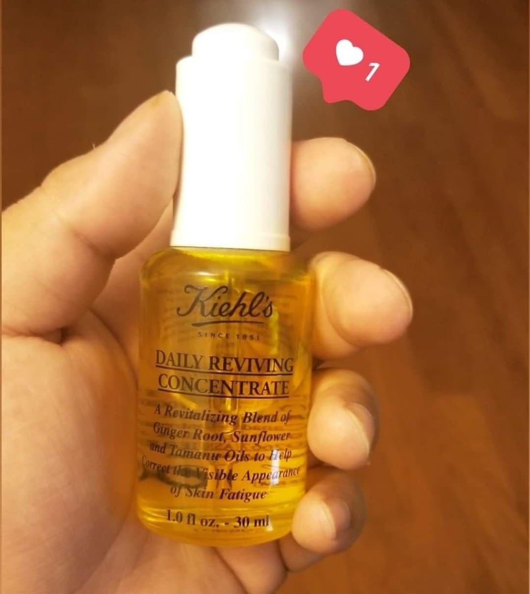 Sarah holding a bottle of Kiehl&#x27;s daily reviving concentrate