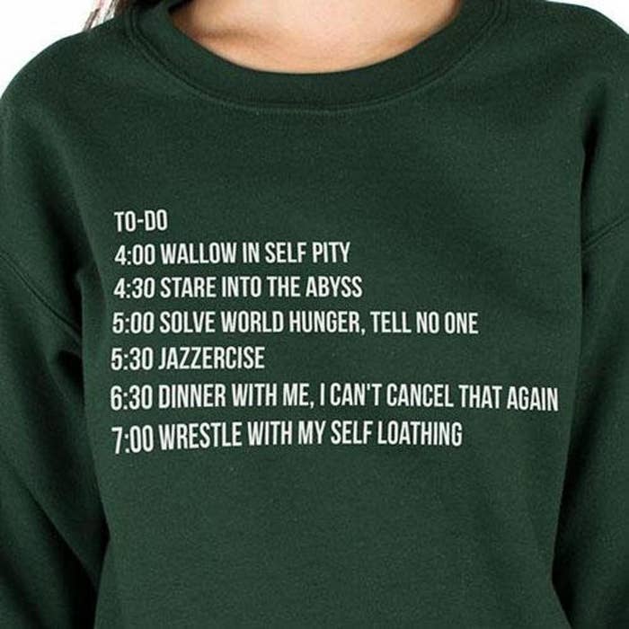 a green sweatshirt with the to-do list from the grinch movie on it