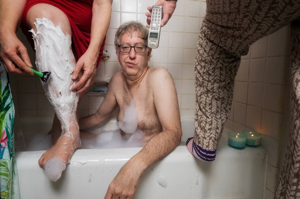 Man in bathtub between two different women