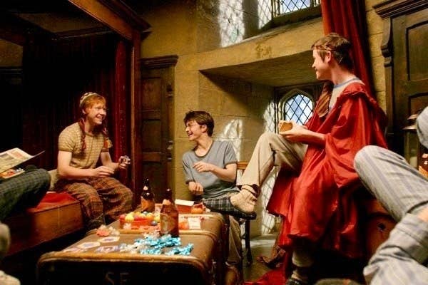 Ron, Harry, and other Gryffindor boys in their dormitory laughing together