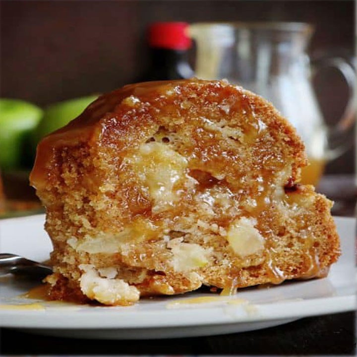 A slice of moist, gooey apple bundt cake.