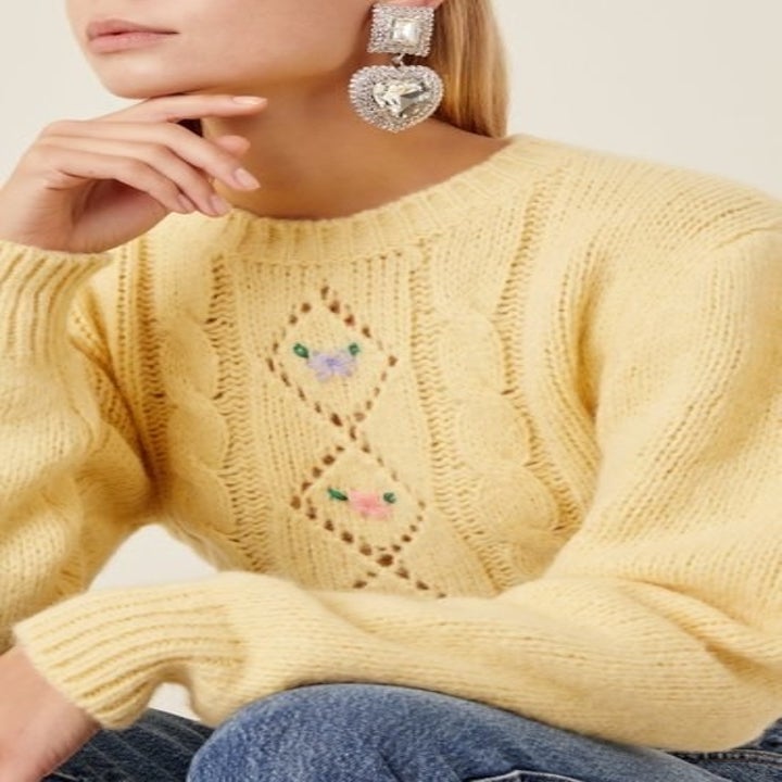 model wearing large heart-shaped crystal clip earrings 