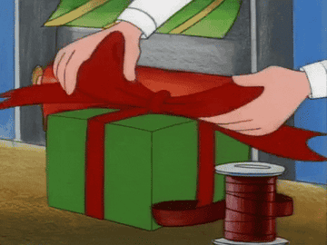 Hands tighten a ribbon on a present