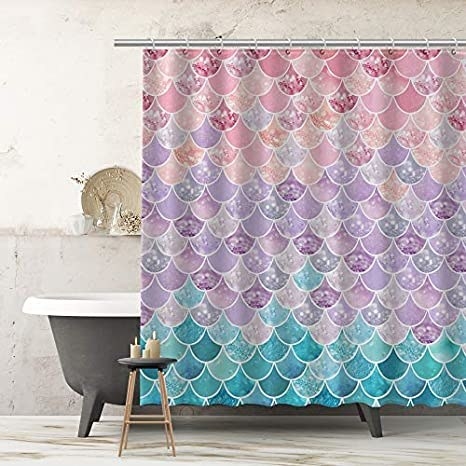 A shower curtain with a pattern that mimicks a mermaid&#x27;s tail