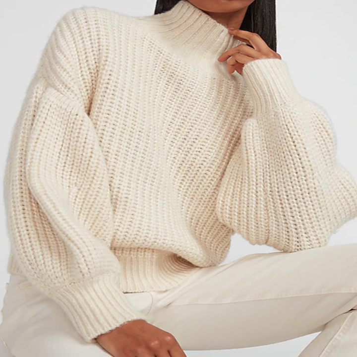 Model wearing cream balloon-sleeve sweater with jeans