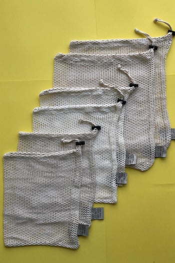 six different-sized reusable mesh produce bags with drawstring closures