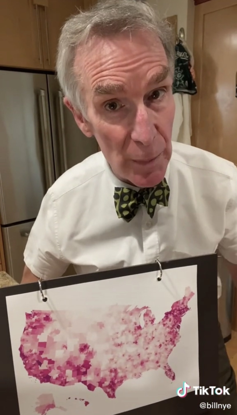 Bill Nye in front of a map with highlighted red areas