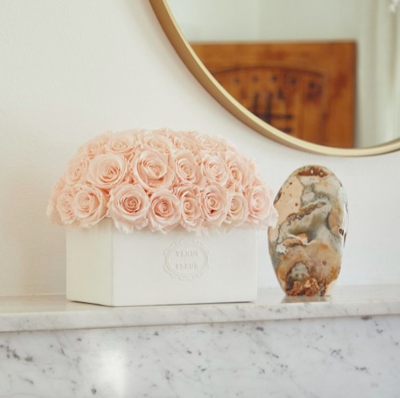 box of light pink roses on a marble counter