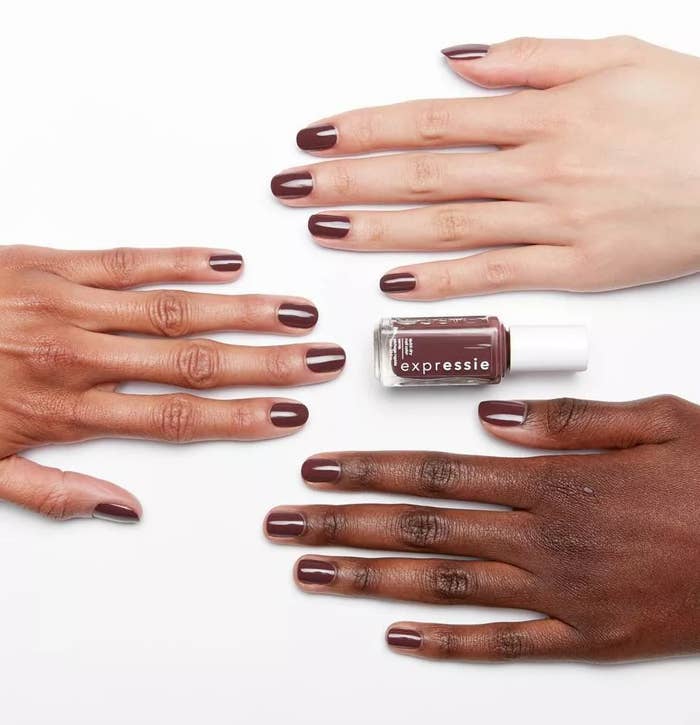 The dark purple &quot;Scoot Scoot&quot; polish against three different skin tones