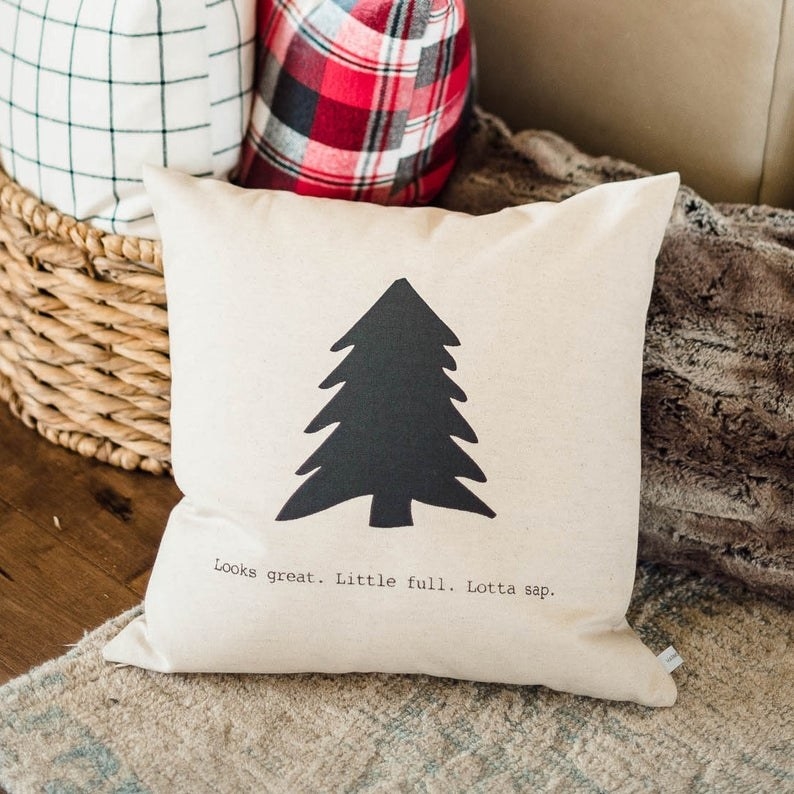 the throw pillow with a tree on it and the quote &quot;looks great, little full, lotta sap&quot;