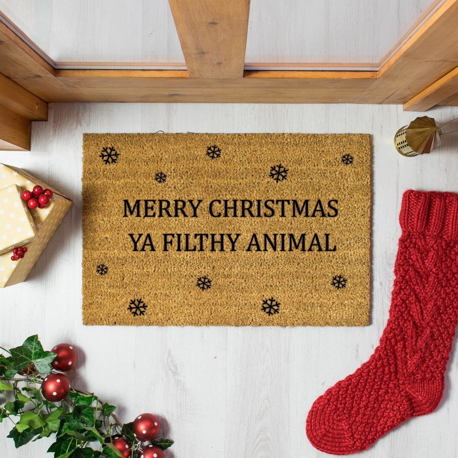 a doormat that says &quot;merry christmas ya filthy animal&quot; on it