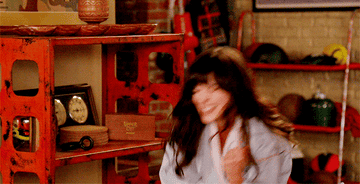 Jess Day from New Girl making a &quot;yes!&quot; gesture 