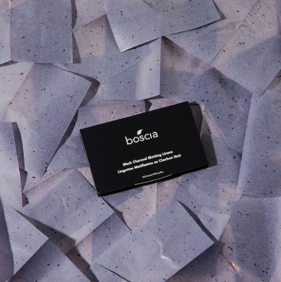 A packet of blotting linens on a bed of charcoal-infused blotting linens