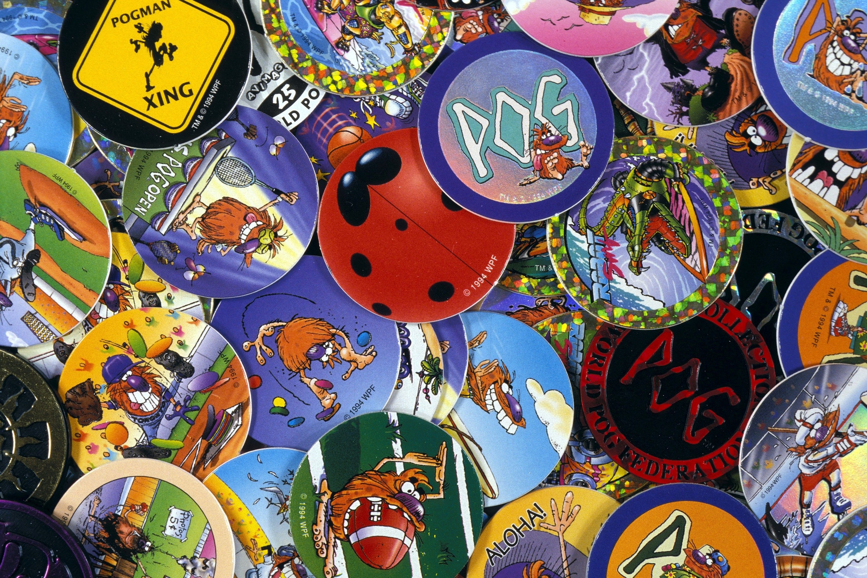 A bunch of pogs with different images. 