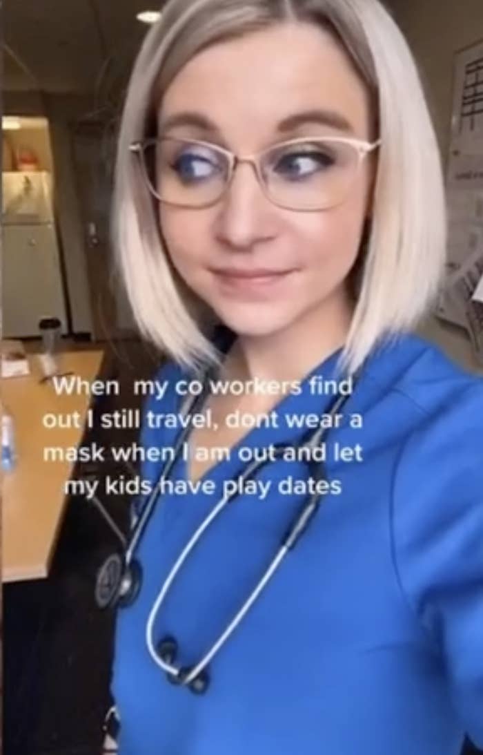 A screenshot from a TikTok video shows a nurse smiling in blue scrubs and a stethoscope with a caption reading &quot;when my coworkers find out I still travel, don&#x27;t wear a mask when I am out, and let my kids have playdates&quot;