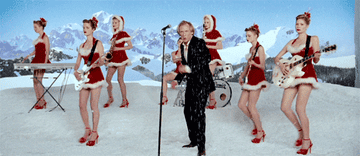 Bill Nighy as Billy Mack dancing with a Christmas-themed band in &quot;Love Actually&quot;