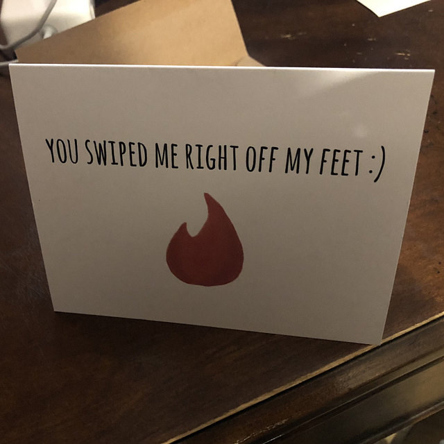 A white card with a drawing of an orange flame, and the words "You swiped me right off my feet :)"