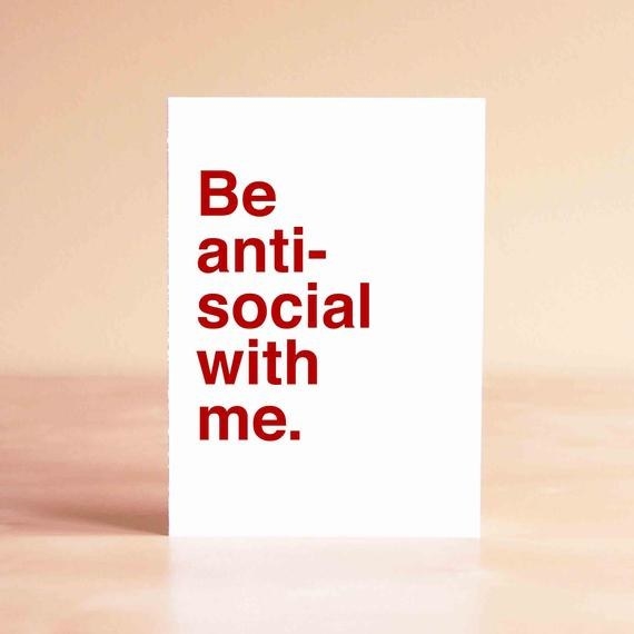 A white card that says "Be anti-social with me" in red type
