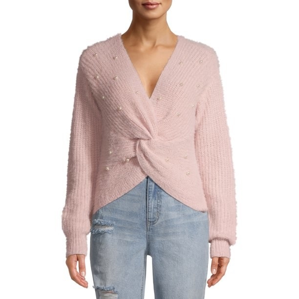 Model in pink twist sweater with pearl decals