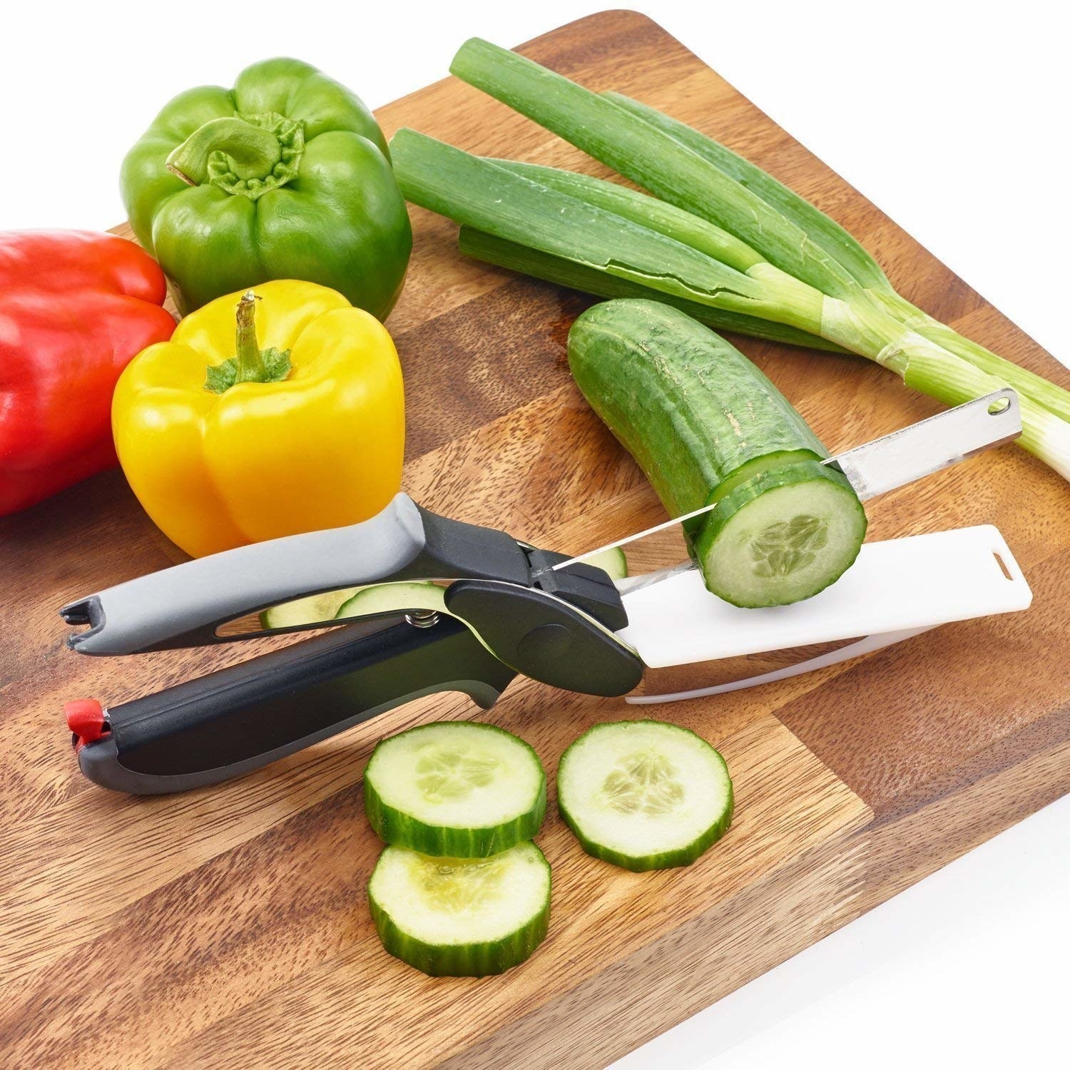 The spring action knife pictured with a sliced cucumber.