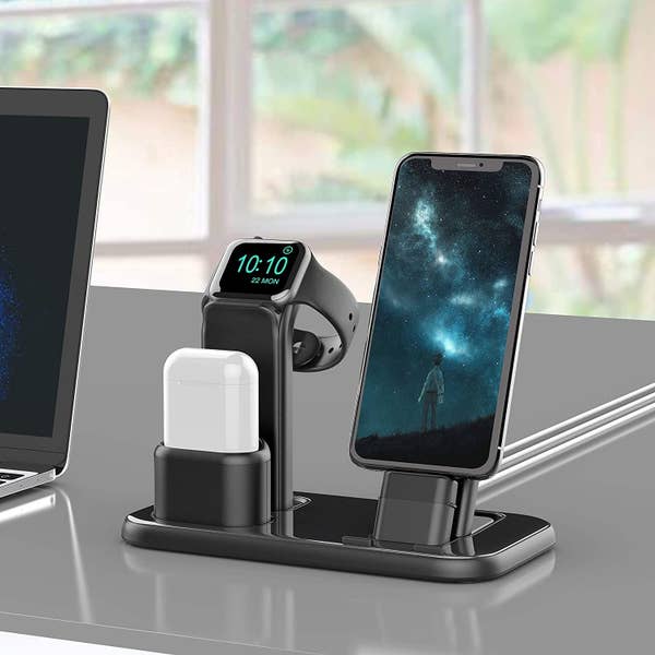 Black three in one charging station with white AirPods, black iPhone and black Apple watch