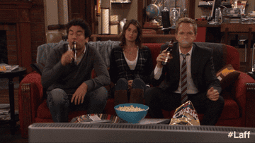 Barney and Ted spitting out drinks while Robin smirks