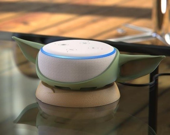 An Echo Dot inside the Baby Yoda holder