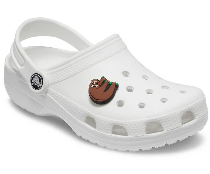 sloth charm attached to a white Croc shoe 