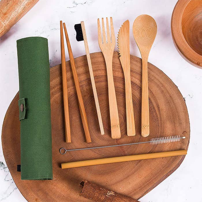 bamboo cutlery set laid out on a wooden plate 