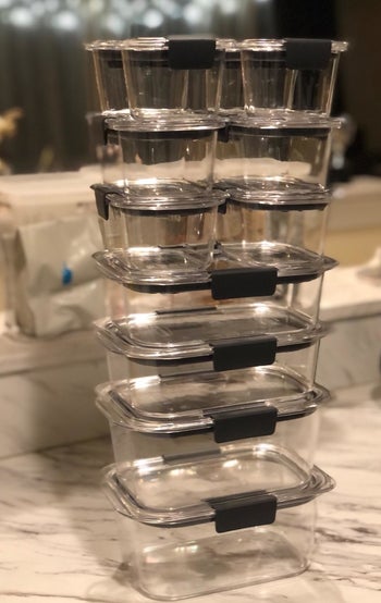 Reviewer photo of the 24-piece clear container set stacked in an organized column from largest at the bottom to smallest on the top 