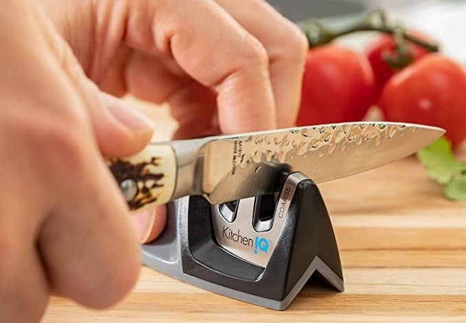 a model sharpening a knife in the small sharpener