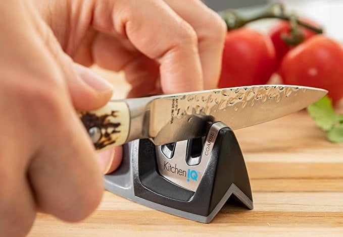 a model sharpening a knife in the small sharpener