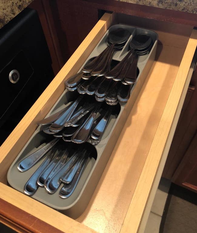 Reviewer photo of an open drawer with all their silverware organized in the drawer organizer 