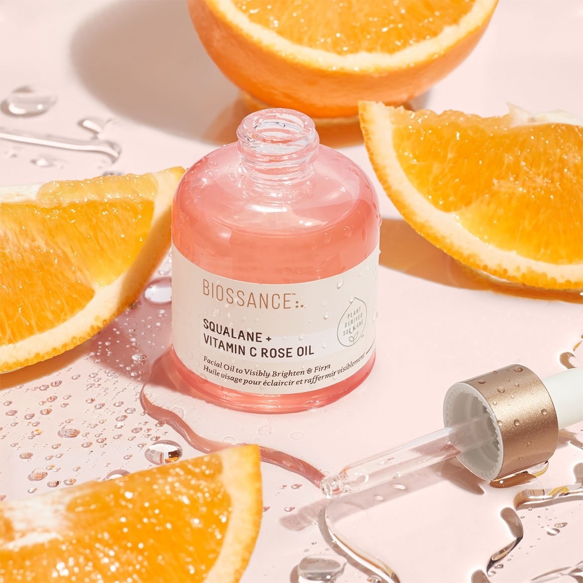 the squalane and vitamin c rose oil surrounded by orange slices