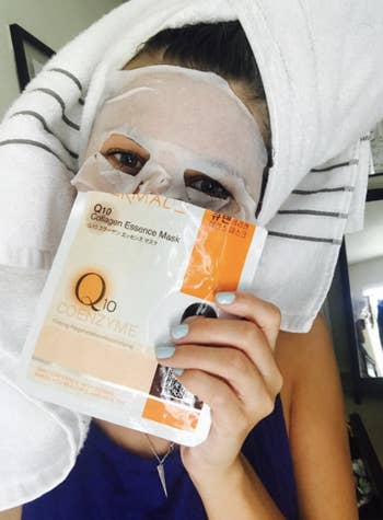 Reviewer using sheet mask holding up package