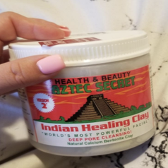 Reviewer holding tub of mask