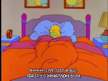 Homer Simpson in bed saying ahhh I&#x27;m just a big toasty cinnamon bun
